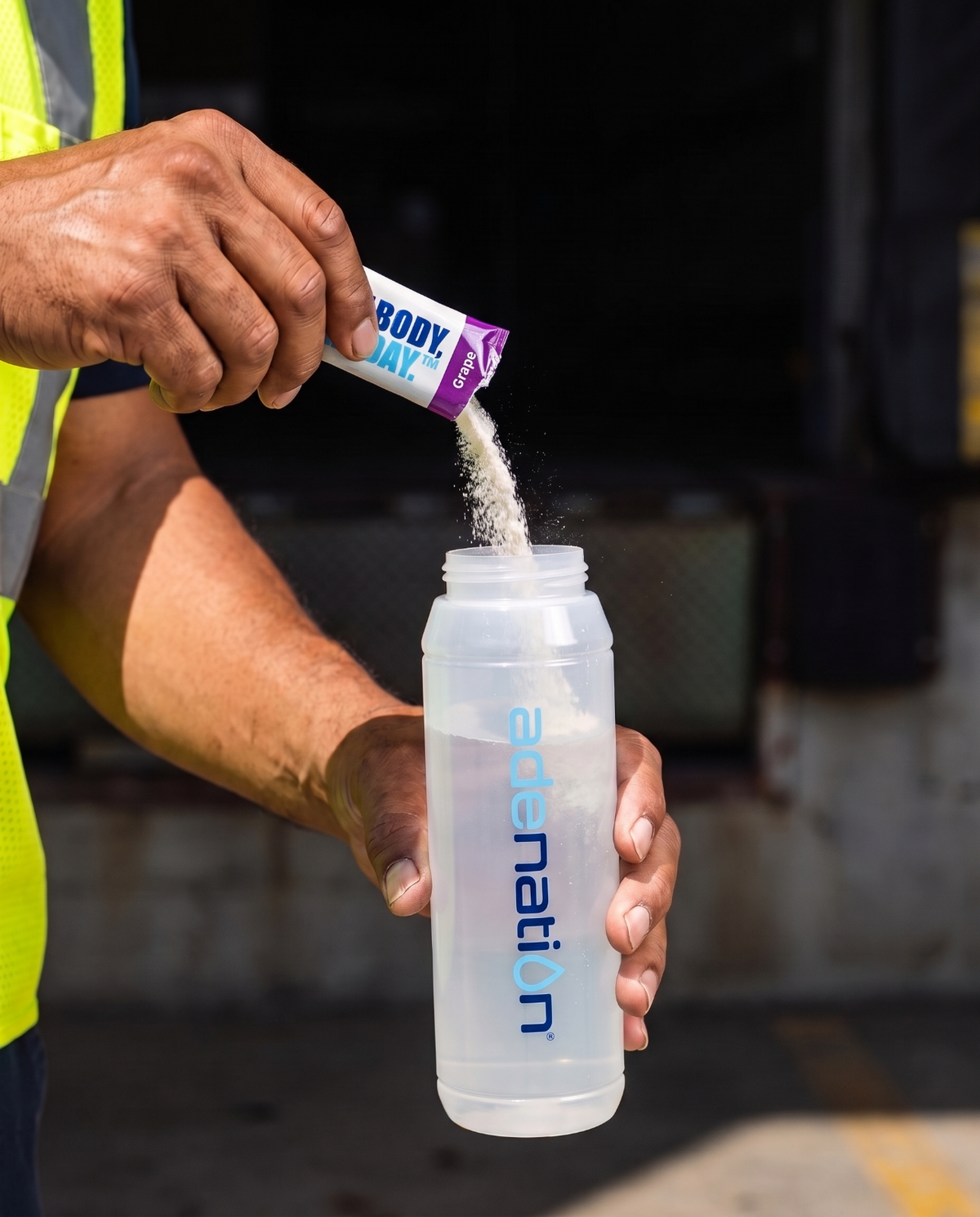 Pouring an AdeNation stick into a bottle